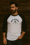 Man wearing a 'Old Soren' baseball shirt against a wooden background
